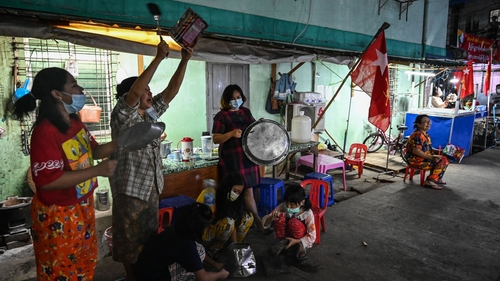 People in Yangon bang pots in protest over the coup