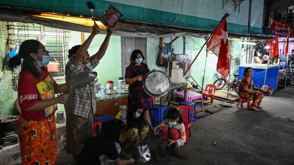 People in Yangon bang pots in protest over the coup