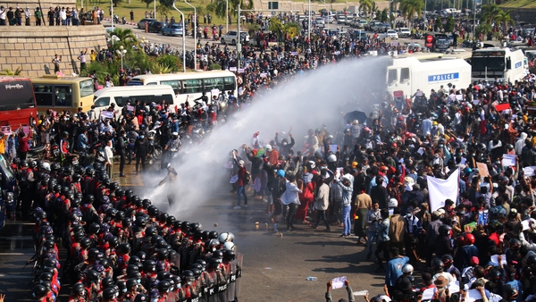 Protesters face off riot police during a demonstration against the military coup in the Myanmar capital Naypyidaw