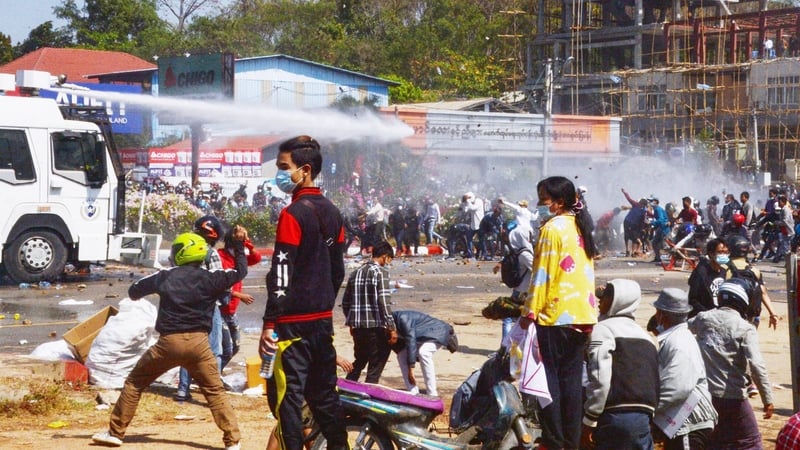 Protesters confront a police water cannon vehicle in the Myanmar capital Naypyidaw