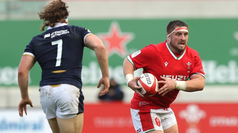 Wyn Jones (R) runs with the ball against Scotland last October