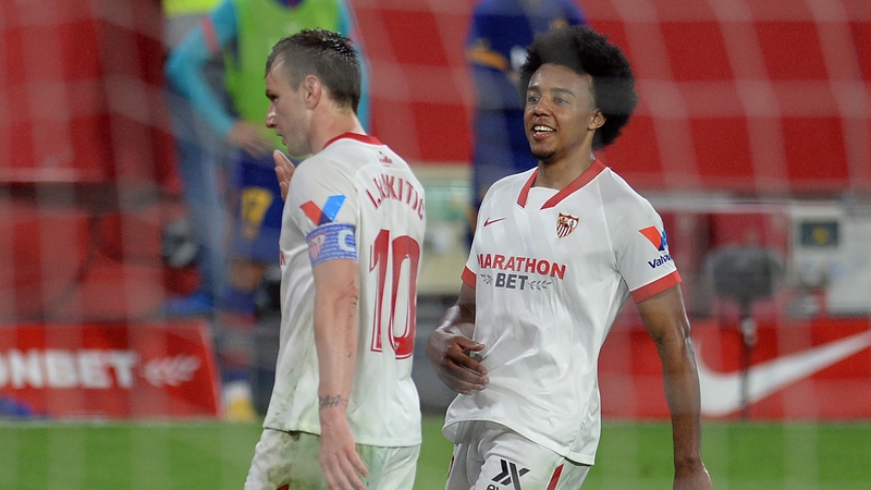 Ex-Barcelona midfielder Ivan Rakitic (L) celebrates with Jules Kounde