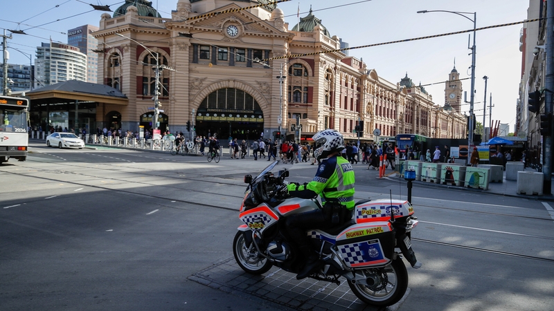 A policeman patrols on a motorcycle in Melbourne after authorities ordered a five-day state-wide lockdown