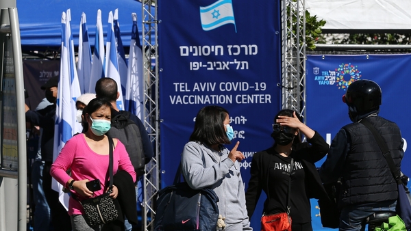 People queue outside a vaccination centre in Tel Aviv