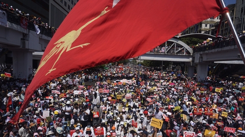 Protesters block a major road during a demonstration against the military coup in Yangon