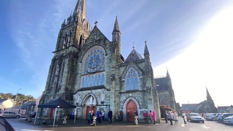 Parishioners queue at the Church of the Immaculate Conception for takeaway ashes