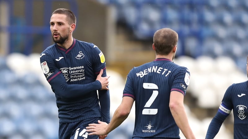 Conor Hourihane is congratulated by Swansea team-mate Ryan Bennett after scoring a free-kick