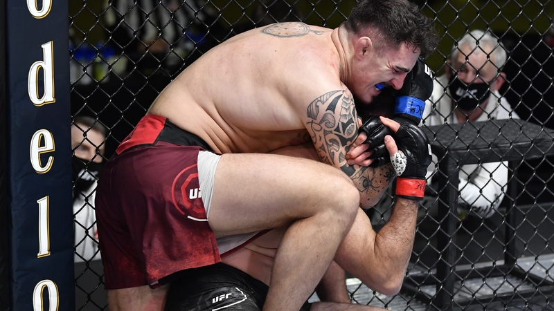 Tom Aspinall secures a rear choke submission against Andrei Arlovski