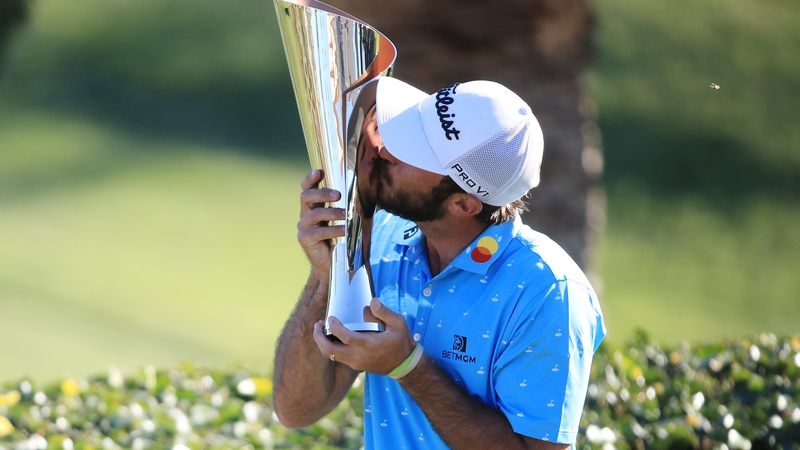 Max Homa celebrates with the trophy
