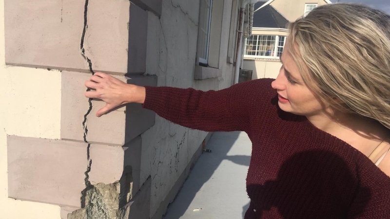 Christina Crumlish shows the cracks on the walls of her house