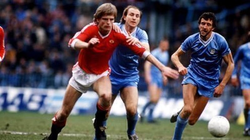 McQueen in action for Manchester United against Manchester City in 1983