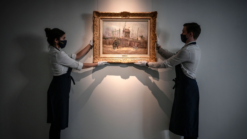 The painting depicts a man and woman strolling arm in arm past a ramshackle fence with a windmill in the background