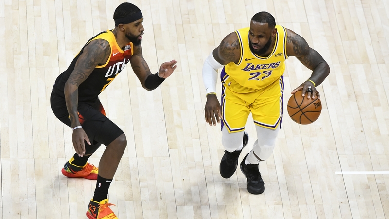 LeBron James of the Los Angeles Lakers drives into Royce O'Neale of Utah Jazz