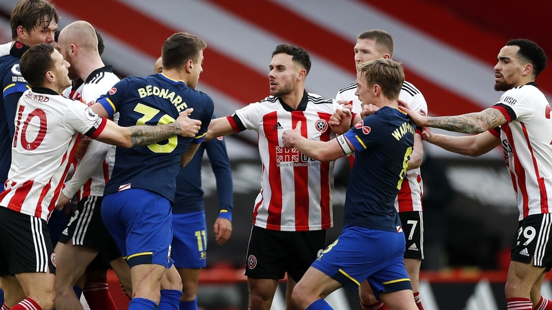 Tempers flare after a late challenge by John Fleck on goalscorer Che Adams