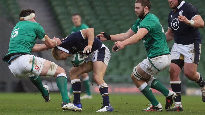 Scotland's Jaco Van Der Walt (c) is tackled by James Ryan (l) and Iain Henderson during the Autumn Nations Cup