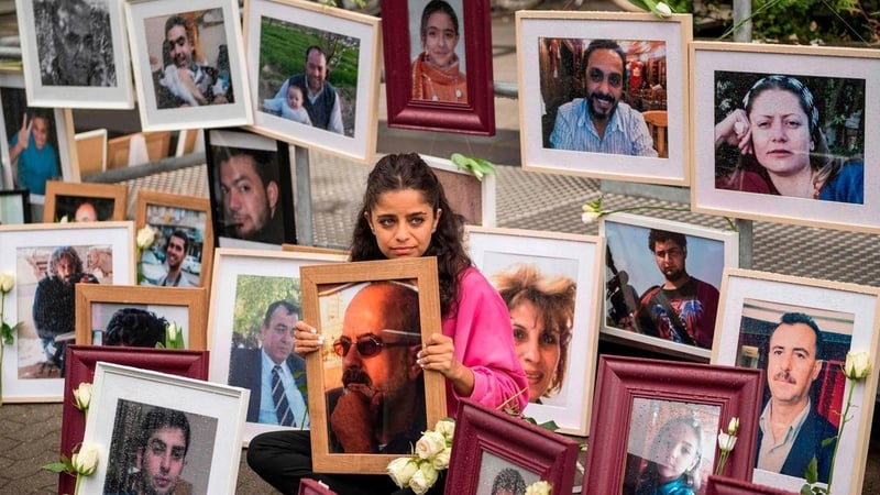 Wafa Mustafa holding a photo of her dad Ali