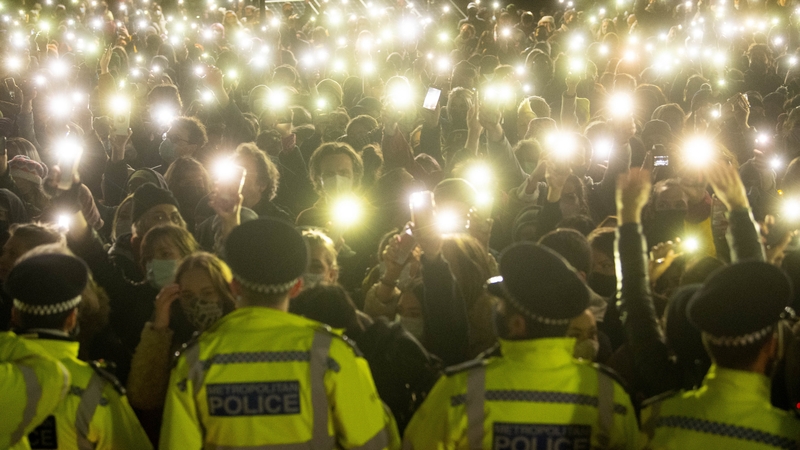 People in the crowd turn on their phone torches as they gathered in Clapham Common in London