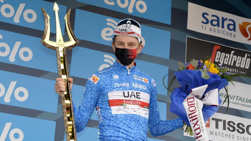Tadej Pogacar celebrates on podium after winning the Tirreno-Adriatico
