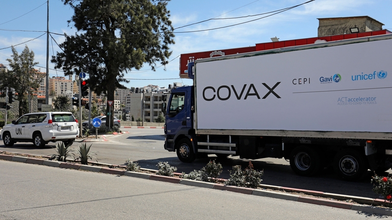 A refrigerated truck loaded with the first delivery of coronavirus vaccine via the Covax programme drives toward the West Bank city of Ramallah