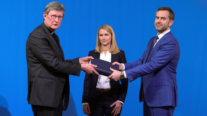 Lawyer Kerstin Stirner looks on as Bjoern Gercke hands the report to Archbishop Rainer Maria Woelki (L)