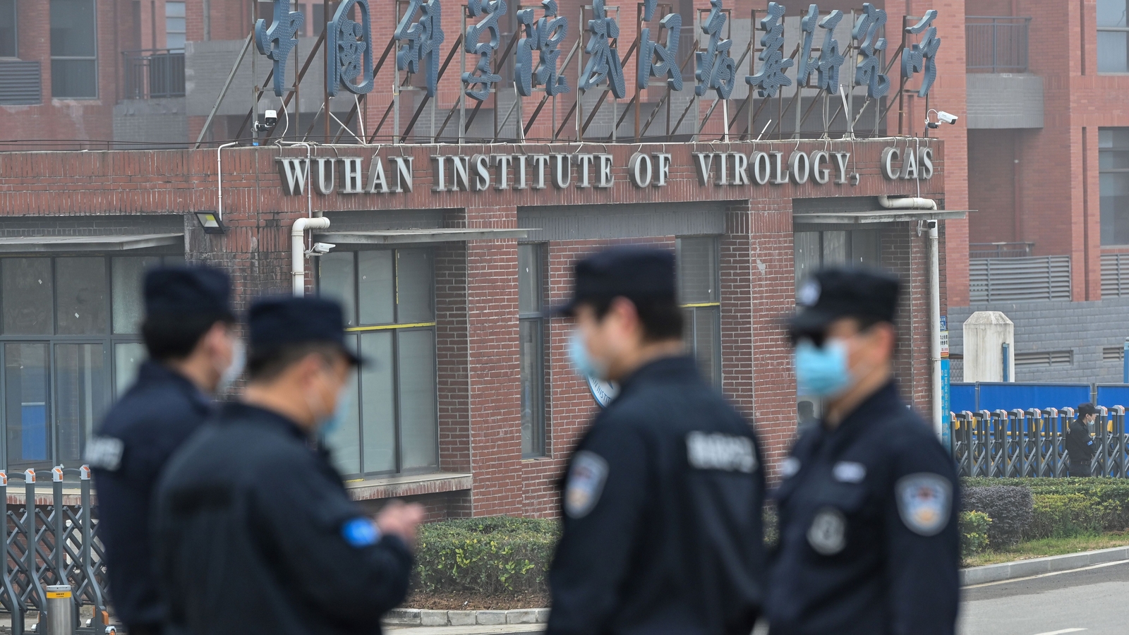 Security stand guard outside the Wuhan Institute of Virology as members of the World Health Organisation visit the institute