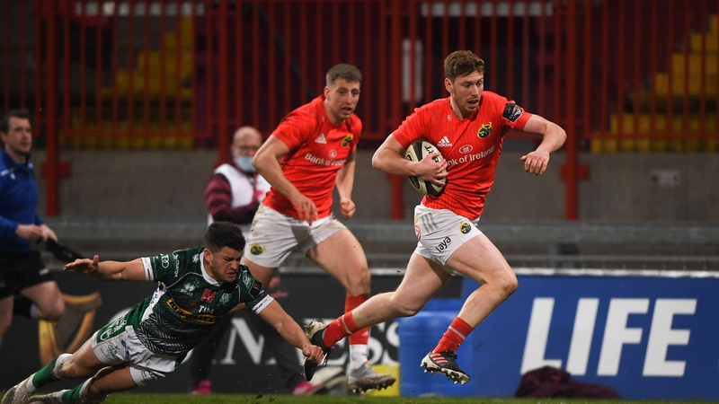 Ben Healy goes past the tackle of Luca Petrozzi on his way scoring Munster's fourth try