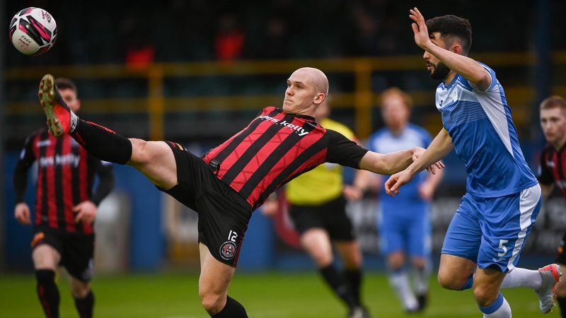 Georgie Kelly stretches for the ball under attention from David Webster