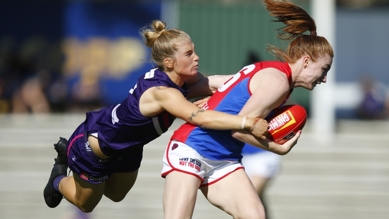 Lauren Magee is tackled by Jasmin Stewart of the Dockers
