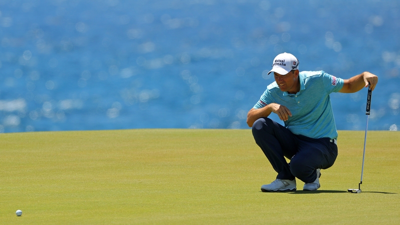 Padraig Harrington lines up a putt on the eighth green