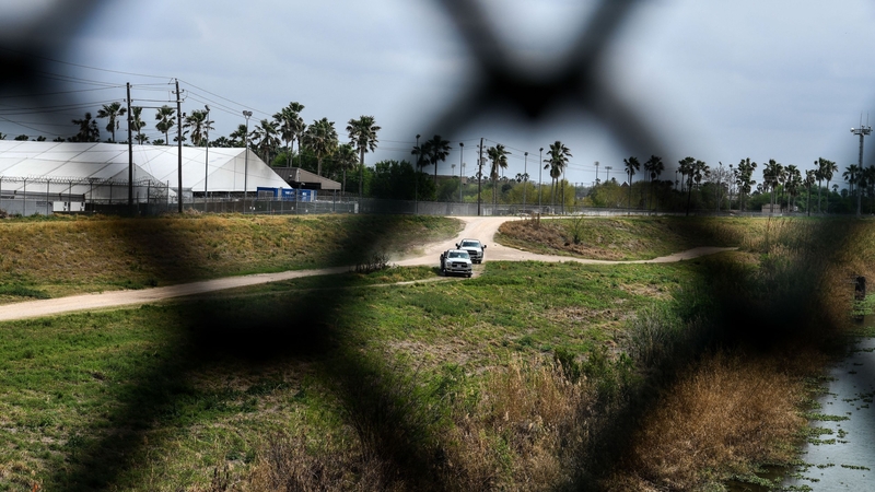 US Border Patrol cars patrol along the border with Mexico