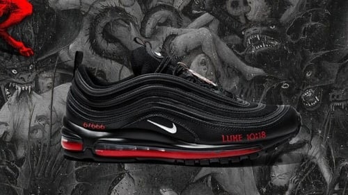 The black Nike Air Max 97s have been customised to feature a bronze pentagram, a Bible verse referring to Satan's fall and a drop of human blood mixed with red ink in the midsole (Pic: MSCHF website)