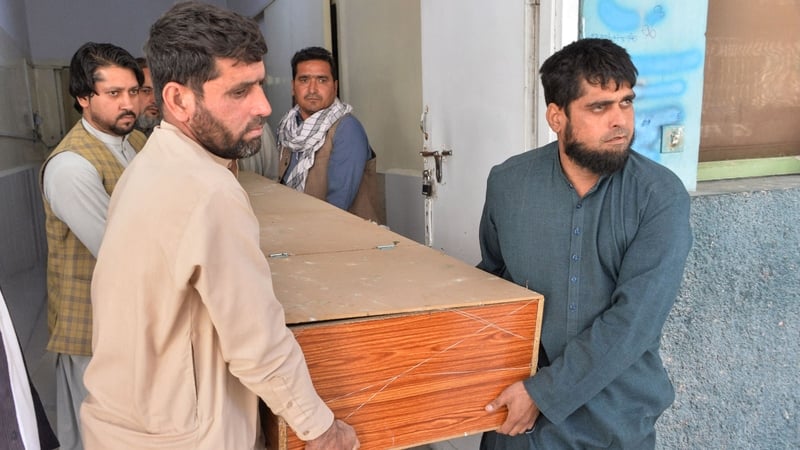 Relatives transport the body of one of the polio workers who was shot dead in Jalalabad today