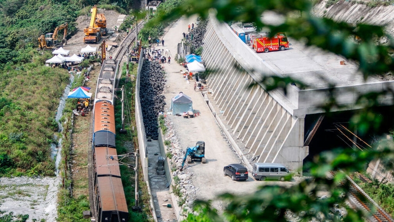 An overview of the damaged train lifted and removed from a track for clearance after derailing in a tunnel