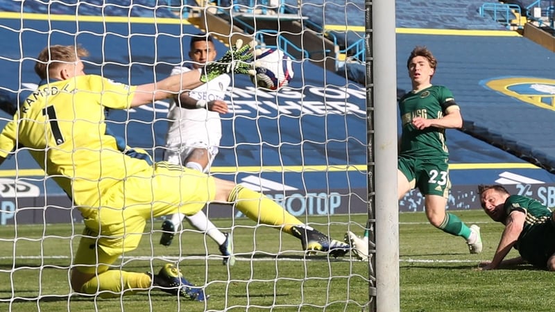 Phil Jagielka (right) deflects the ball past Aaron Ramsdale