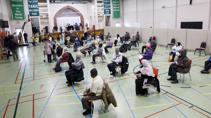 Healthcare workers administer Moderna Covid-19 vaccinations to members of the Muslim community in Toronto