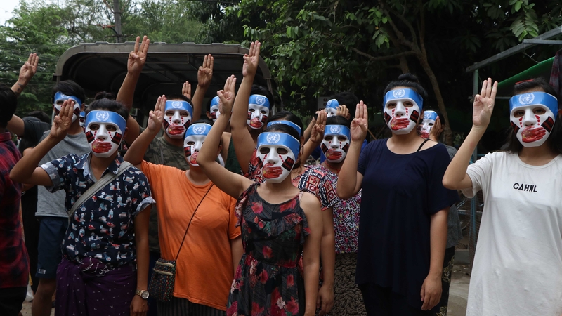 Protesters in masks at a rally in Yangon