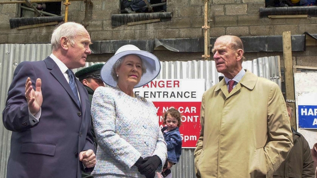 Northern Ireland's Secretary of State, Dr John Reid (L) with Queen Elizabeth and Prince Phillip at the spot where a car bomb exploded in Omagh in 2002