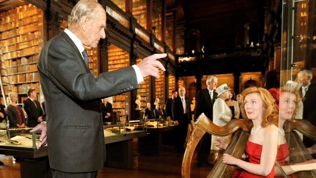 Prince Philip listens to Harpist Siobhan Armstrong as he visits Trinity College Dublin in May 2011