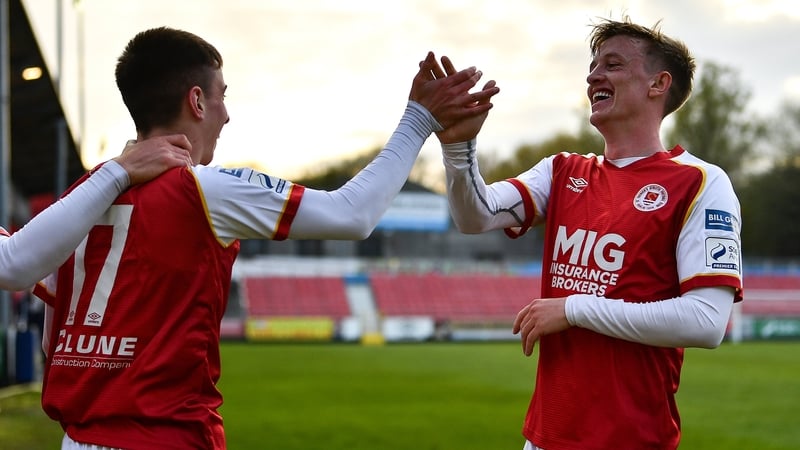 Darragh Burns (L) celebrates with Chris Forrester after scoring his side's second goal