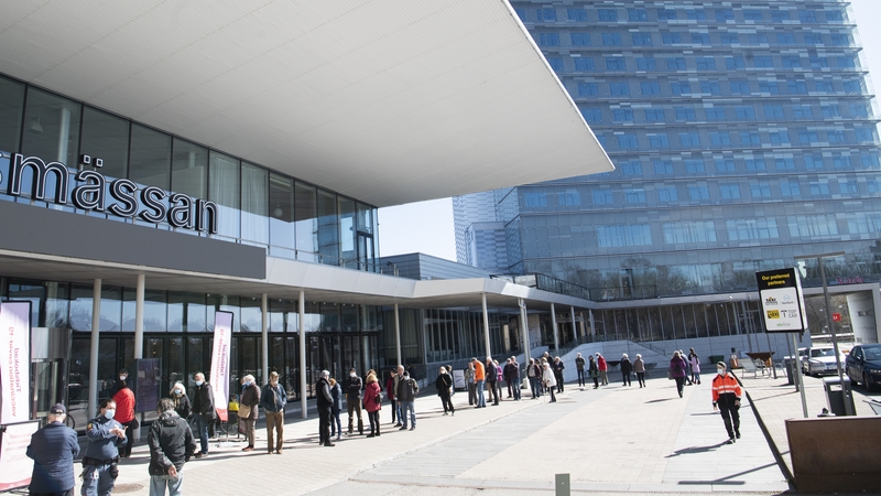 People queue to get a Covid-19 vaccine outside the Stockholmsmassan exhibition centre in Stockholm