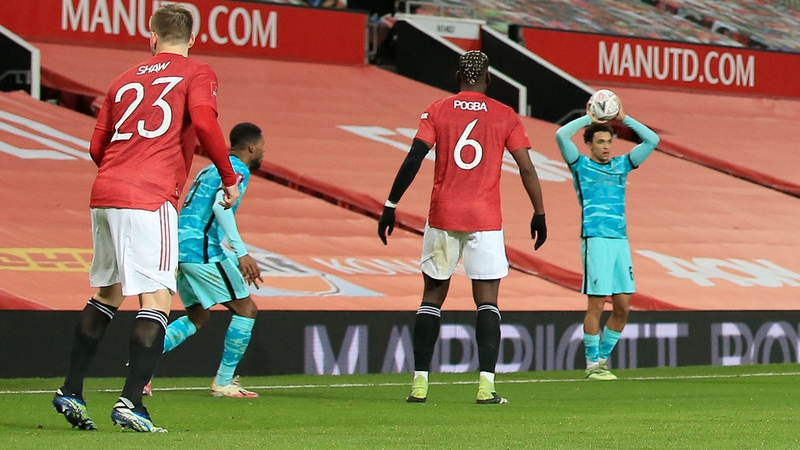 Manchester United and Liverpool players in front of red banners at Old Trafford in January