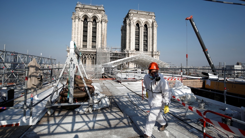 A worker walks on the roof of the Notre-Dame de Paris Cathedral this morning