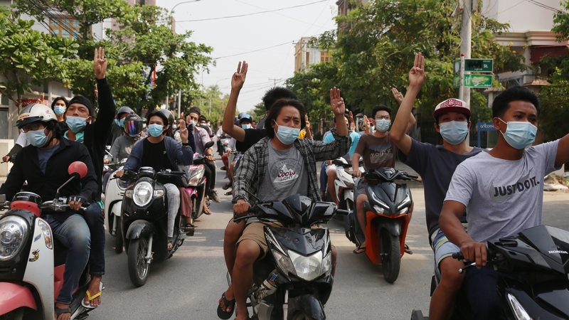 Demonstrators on motorcycles flash the three-finger salute during an anti-military coup protest in Mandalay