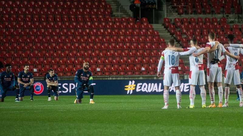 Arsenal's Alexandre Lacazette (C) and his team-mates taking a knee ahead of the game