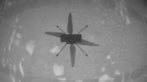 A handout image from NASA shows the shadow of the Ingenuity helicopter during its first test flight on Mars