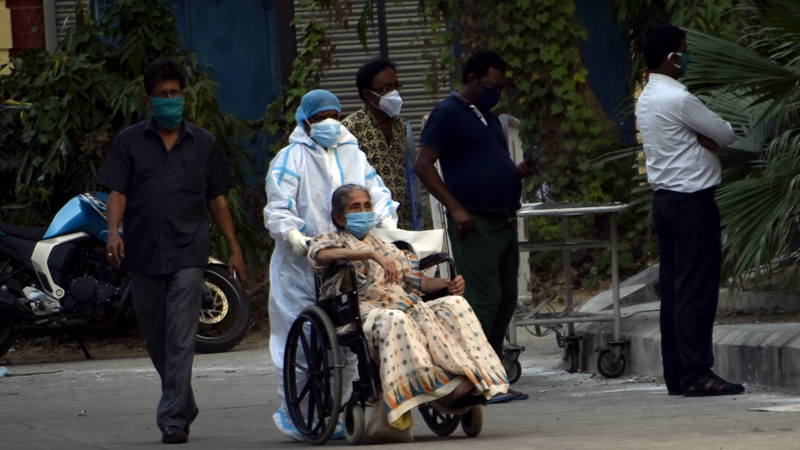 A patient with Covid-19 is brought to a hospital in Kolkata, India