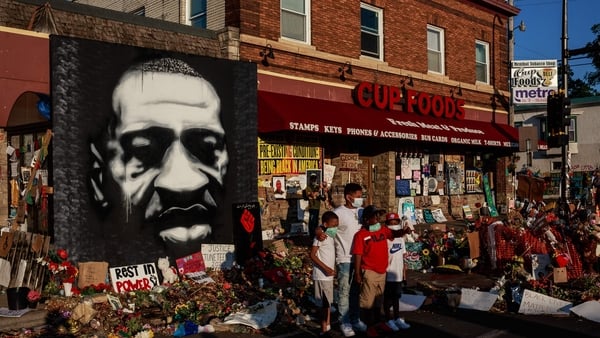 People gather at a makeshift memorial to George Floyd near the site where he died in police custody in Minneapolis