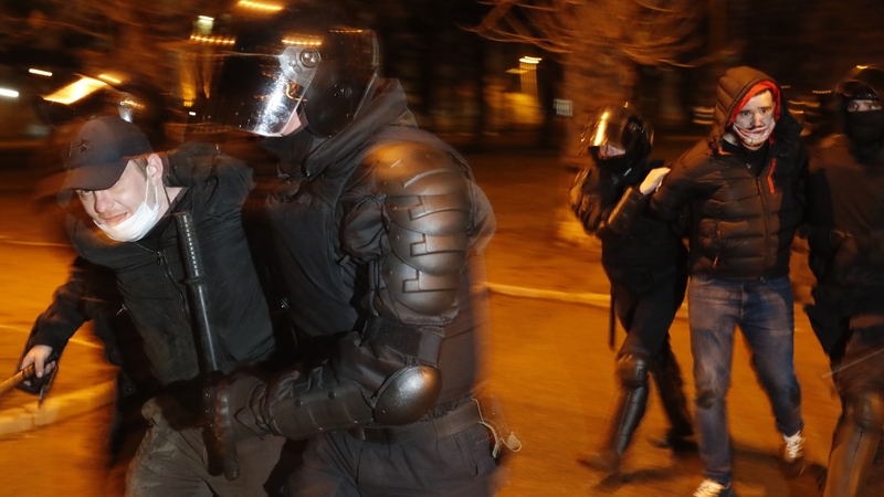 Russian riot police officers detain men during opposition rally in St Petersburg last night