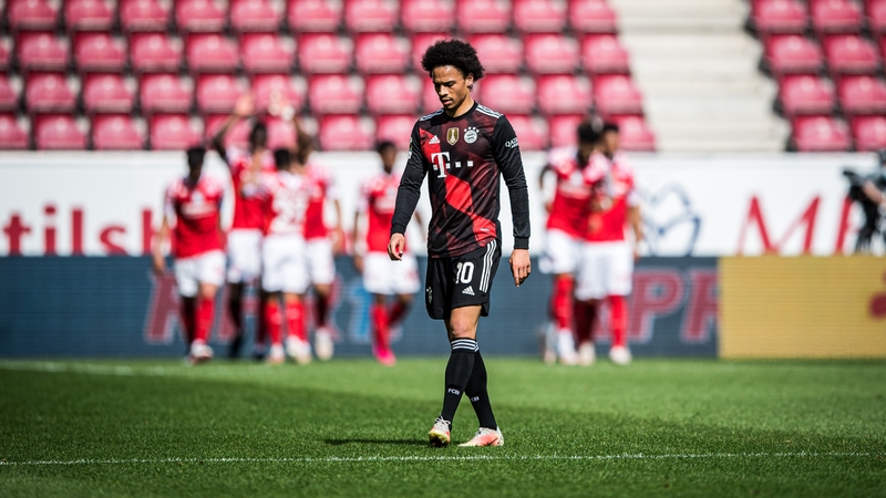 Leroy Sane looks on as Mainz players celebrate their first goal