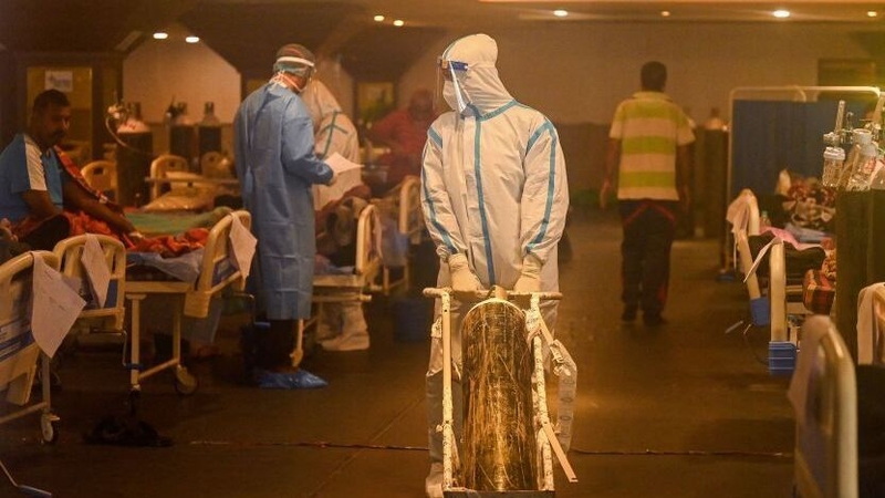 Health workers attend to patients inside a banqueting hall temporarily converted into a Covid-19 care centre in Delhi